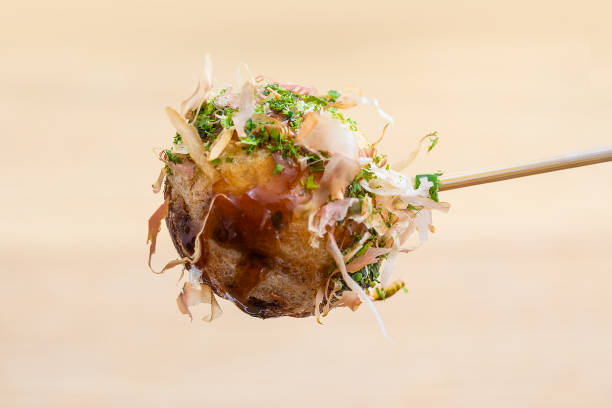 Octopus grill recipe.  Takoyaki close-up with skewers. There is bonito stock photo