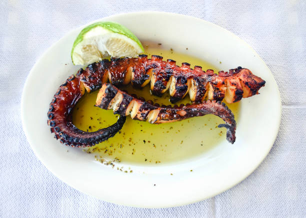 octopus on plate at a greek tavern stock photo