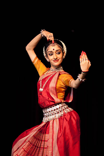 Odissi dancer "Delhi, India - November 20, 2010: A young Indian classical dancer making one of the innumerable mudras (hand & face gestures) of the popular, traditional 'Odissi' classical dance forms of India. The image featuring one of India's top classical dancers is from a session held at the Delhi University Campus." odissi dance stock pictures, royalty-free photos & images