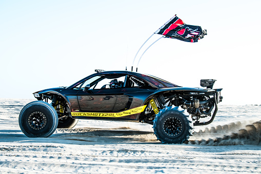 Doha, Qatar- February 23, 2018: Off road buggy car in the sand dunes of the Qatari desert.