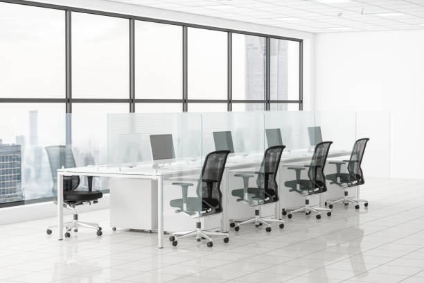 Office Desk With Glass Partition Dividing Them Office Desk With Glass Partition Dividing Them office cubicle stock pictures, royalty-free photos & images