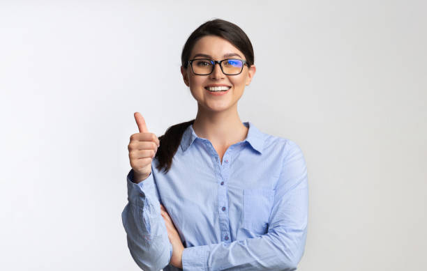 Office Girl Gesturing Thumbs Up Standing On White Background Like. Joyful Office Girl Gesturing Thumbs Up Standing On White Background. Studio Shot business thumbs up stock pictures, royalty-free photos & images