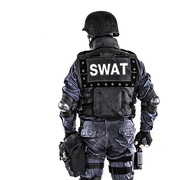 SWAT officer Special weapons and tactics SWAT team officer shot from behind special forces stock pictures, royalty-free photos & images