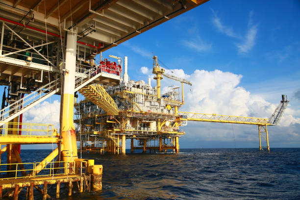 Offshore construction platform for production oil and gas. Oil and gas industry and hard work. Production platform and operation process by manual and auto function from control room. Offshore construction platform for production oil and gas. Oil and gas industry and hard work. Production platform and operation process by manual and auto function from control room. oil refinery factory stock pictures, royalty-free photos & images
