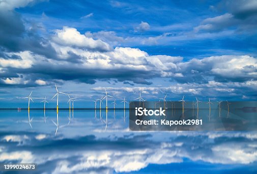 istock Offshore Wind Turbine in a Wind farm under construction off coast of England, UK 1399024673