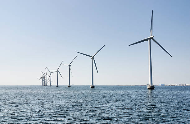 Offshore wind turbines, industrial area in the horizon stock photo