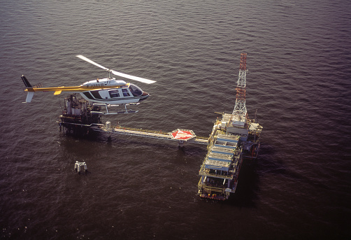 Helicopter flying over oil rig, Maracaibo Lake, Zulia State, Venezuela