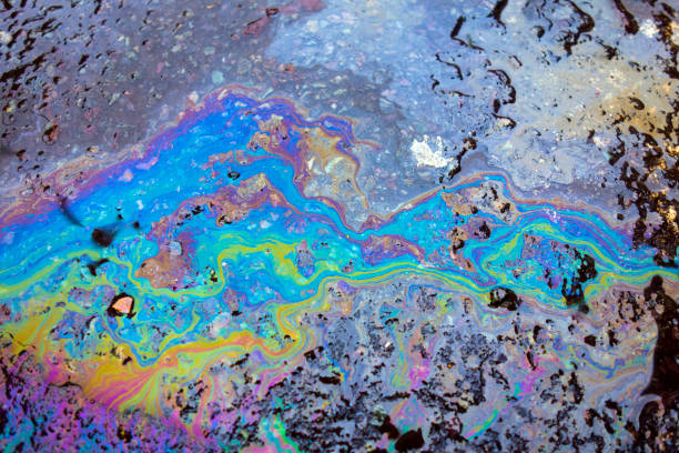 Oil Petrol Pollution Rainbow Gasoline Leak on Pavement stock photo