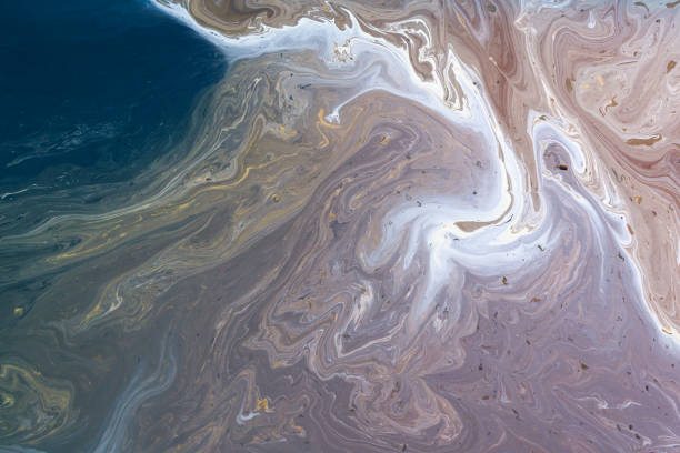 Oil polluted ocean surface as background or backdrop Oil polluted ocean surface as background or backdrop water pollution stock pictures, royalty-free photos & images