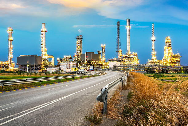 Oil refinery Road to the oil refiner on blue sky in sunset time oil refinery stock pictures, royalty-free photos & images