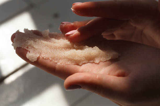 Oil salt scrub. Cosmetic surgery, hand peeling. Massage of female hands peeling preparation Spa and Wellness stock photo