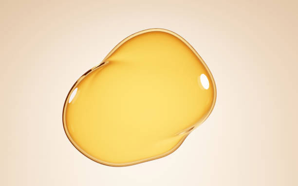 Oil stain, puddles serum or honey isolated on beige background. Mockup liquid cosmetic or food oil, gold serum, collagen essence, 3d illustration, top view on clear yellow water, laboratory research Oil stain, puddles serum or honey isolated on beige background. Mockup liquid cosmetic or food oil, gold serum, collagen essence, 3d illustration, top view on clear yellow water, laboratory research. essential oil stock pictures, royalty-free photos & images