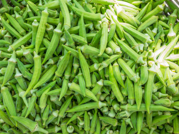 Okra vegetables on market stall. Fresh and organic close up ripe okra vegetable on market stall. okra photos stock pictures, royalty-free photos & images