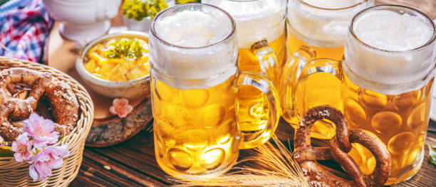 Oktoberfest beer, pretzels and various Bavarian specialties on wooden background stock photo