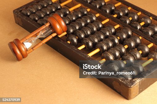 old-abacus-with-sandglass-picture-id524370939