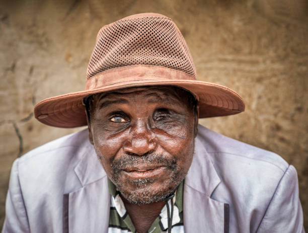 old african blind man with a hat stock photo