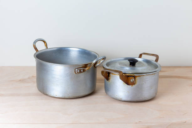 old aluminum pans with a lid on the kitchen table stock photo