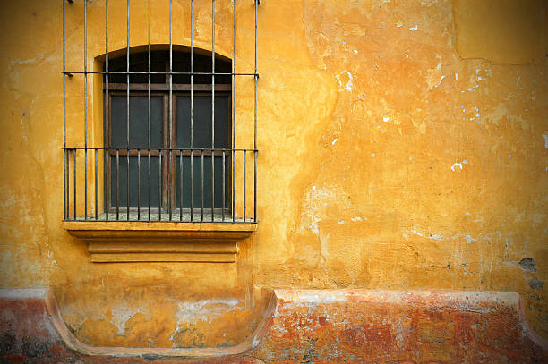 Old Barred Window and Wall in Antigua, Guatemala stock photo