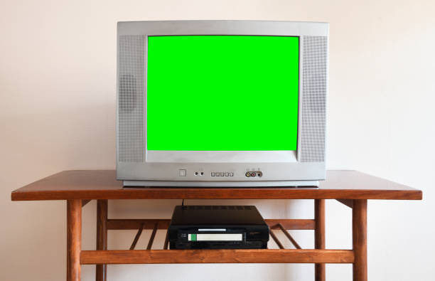 Old black vintage green screen TV from 1980s 1990s 2000s for adding new images to the screen, VCR in the background of wallpaper. Old black vintage green screen TV from 1980s 1990s 2000s for adding new images to the screen, VCR in the background of wallpaper. 90s television set stock pictures, royalty-free photos & images