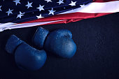Old Boxing gloves and the flag of the United States of America on the floor