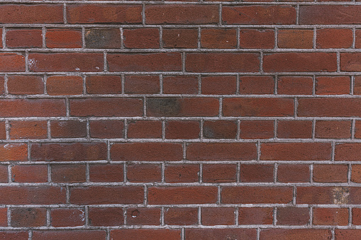 Wall of red plinth bricks as a background