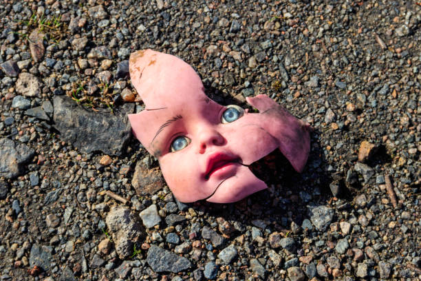 Old broken doll face on ground Old broken doll face on ground broken doll 1 stock pictures, royalty-free photos & images