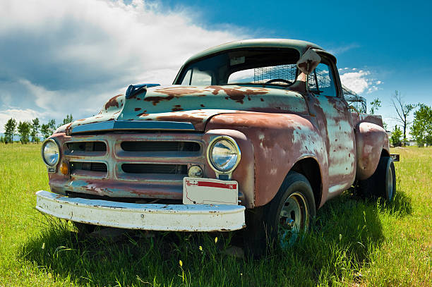 Old broken down pickup truck out in a field. stock photo
