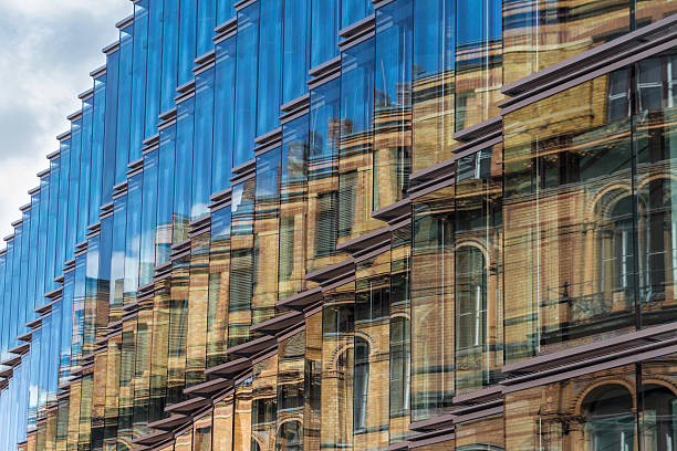old building facade reflection in modern building glass facade old building facade reflection in modern building glass facade - old building facade, new building exterior old vs new stock pictures, royalty-free photos & images