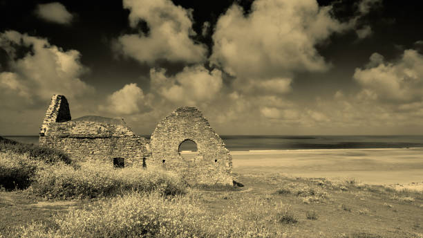 Old Church Image of Vielle Eglise, beach, sea and sand dunes. Black and white image. Carteret, Normandy, France barneville carteret stock pictures, royalty-free photos & images