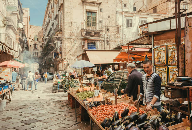 Old city street with vegetable sellers and stalls with tomatoes, eggplant, local farms products stock photo