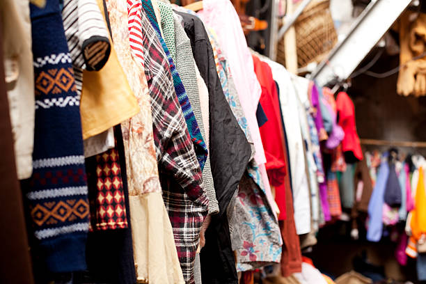 Old clothes in a row Old clothes a row in a flea market second hand sale stock pictures, royalty-free photos & images