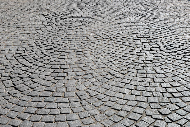 Old cobblestone pavement. Abstract background of old cobblestone pavement close-up. cobblestone stock pictures, royalty-free photos & images