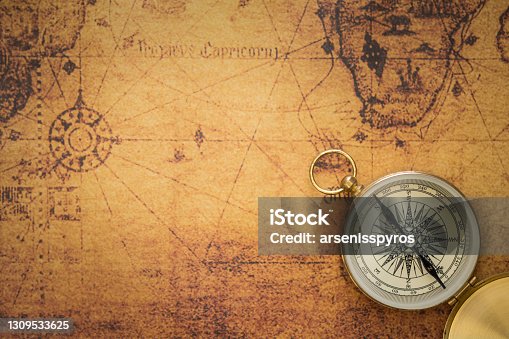 istock Old compass on vintage map 1309533625