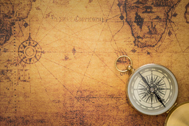 Old compass on vintage map stock photo