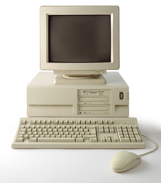 Old computer with monitor, keyboard and mouse on white background stock photo