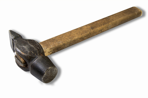 Old construction hammer with wooden handle. Isolated tool on white background. Carpentry by hand