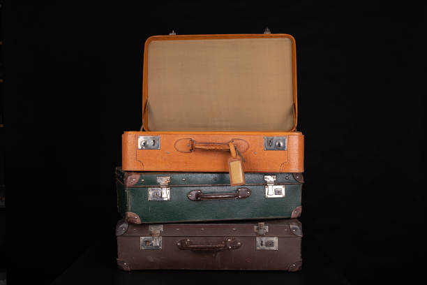 Old destroyed suitcases. Trunks used during long journeys. Dark background.  broken suitcase stock pictures, royalty-free photos & images