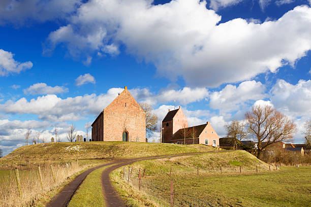 Old Dutch village built on a mound "The old village of Ezinge in the northern province of Groningen. In The Netherlands, to protect villages from the nearby sea, houses were build on high man-made mounds, called a 'terp' or 'wierde' in Dutch." groningen city stock pictures, royalty-free photos & images