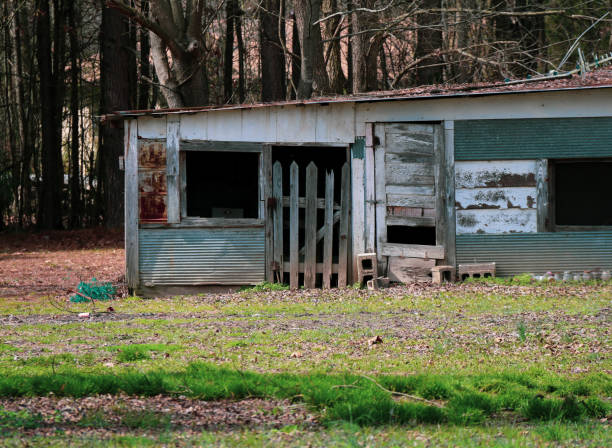 old empty abandoned shed farm building made with spare parts and falling apart rundown deserted stock photo