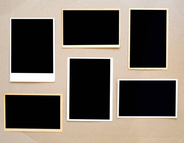 old empty photo frames, vintage photo prints on cardboard with free pics space stock photo