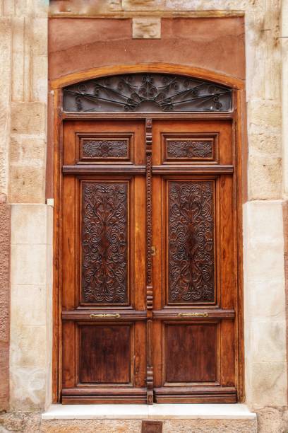 Old facade and entrance of majestic house in Alcaraz, Albacete province, Spain Old stone facade made of carved stone and vintage wooden door in a majestic house in Alcaraz, Albacete province, Spain. alcaraz stock pictures, royalty-free photos & images