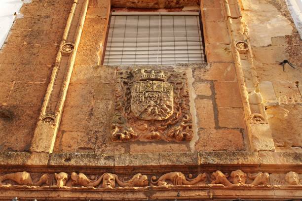 Old facade of majestic house with coat of arms in Alcaraz, Spain Old stone facade made of carved stone with coat of arms in Alcaraz, Castile-la Mancha, Spain alcaraz stock pictures, royalty-free photos & images