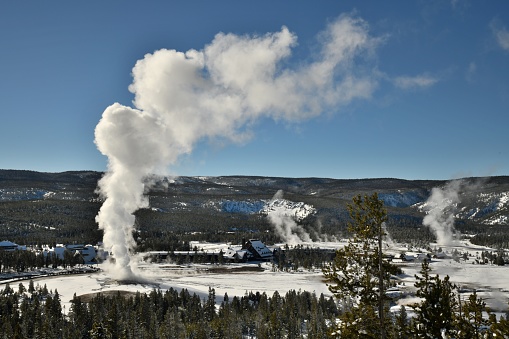 Old Faithful erupts during the winter in Yellowstone National Park