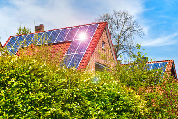 Old family houses modernized with solar panels on the tile roof stock photo