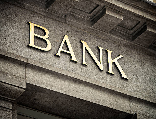 Old Fashioned Bank Sign An old fashioned 'Bank' sign on a building exterior. bank financial building stock pictures, royalty-free photos & images