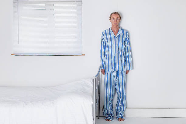 Old Fashioned Man In His Stark Bedroom stock photo