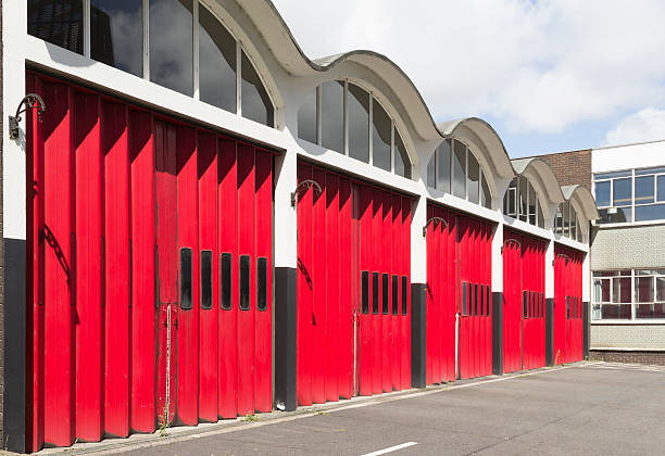 Old fire station red garage concertina doors stock photo