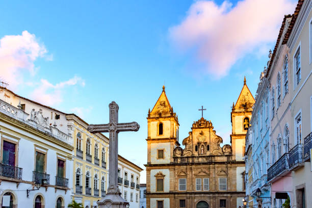 Old houses and churches in colonial and baroque style with a crucifix in the central square of the Pelourinho Old houses and churches in colonial and baroque style with a crucifix in the central square of the historic Pelourinho district in Salvador, Bahia pelourinho stock pictures, royalty-free photos & images