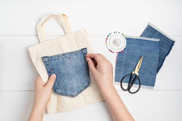 Old jeans upcycling idea. Crafting with denim, recycling old clothers, hobby, diy activity stock photo