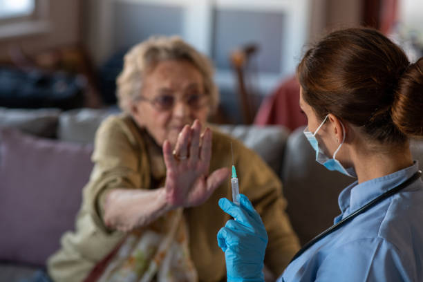 Old lady refuses to be vaccinated. stock photo